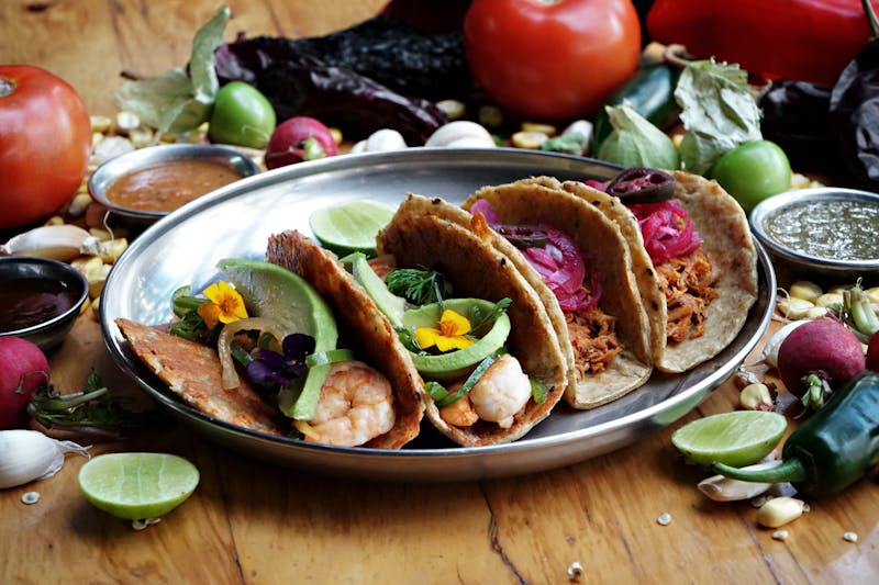 Sweet pork tacos with colorful toppings